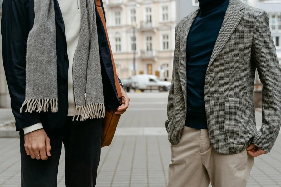 Two men wearing blazers standing on a pathway