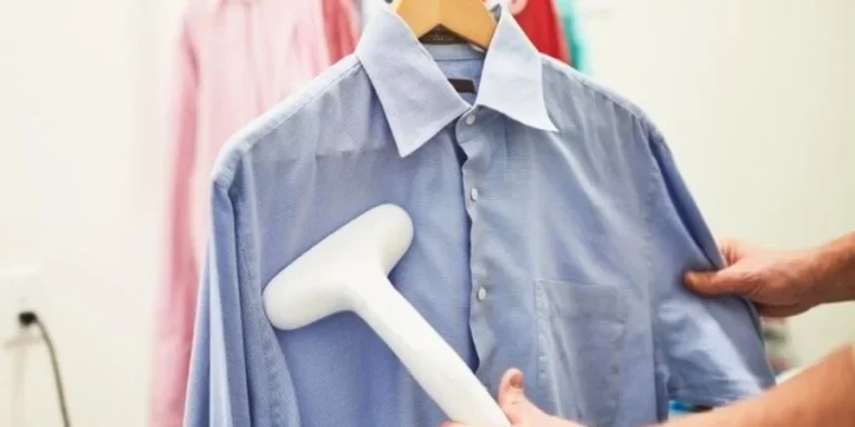 Unrecognizable man steaming up a dress shirt