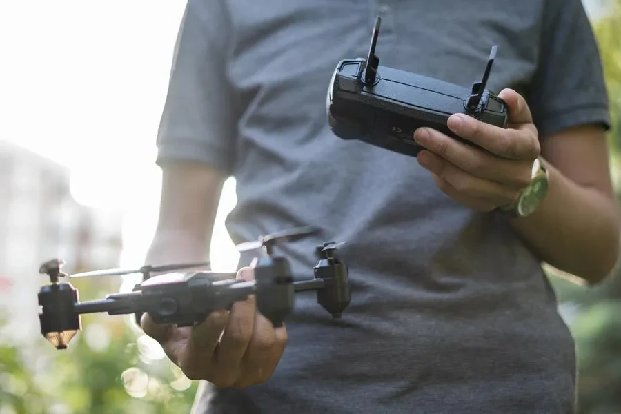 Unrecognizable young man holding a drone and a remote control