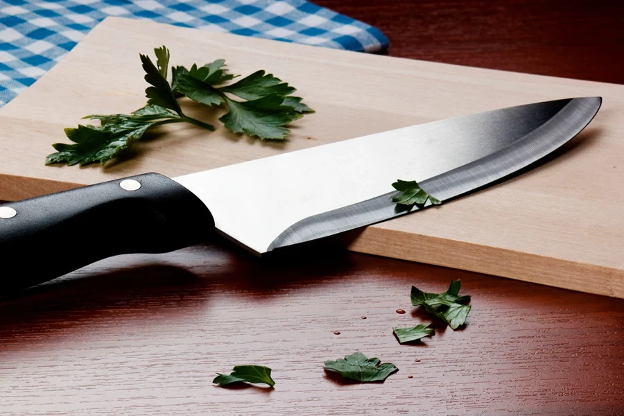 Very sharp knife on a wood cutting board