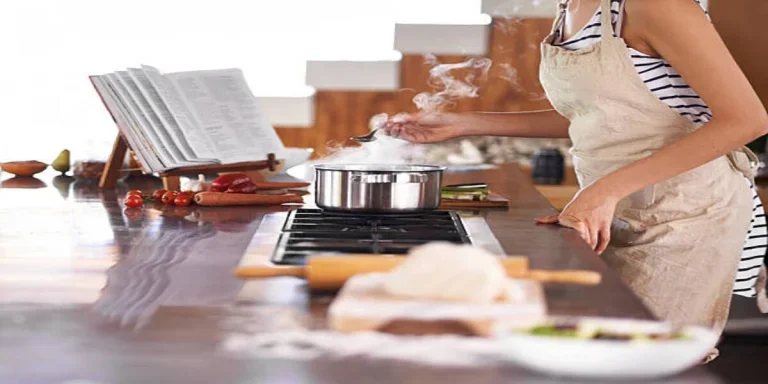 Woman cooking while using wooden cookbook stand