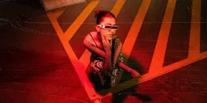 Woman with Fishnet Sleeves Crouching in Red Light