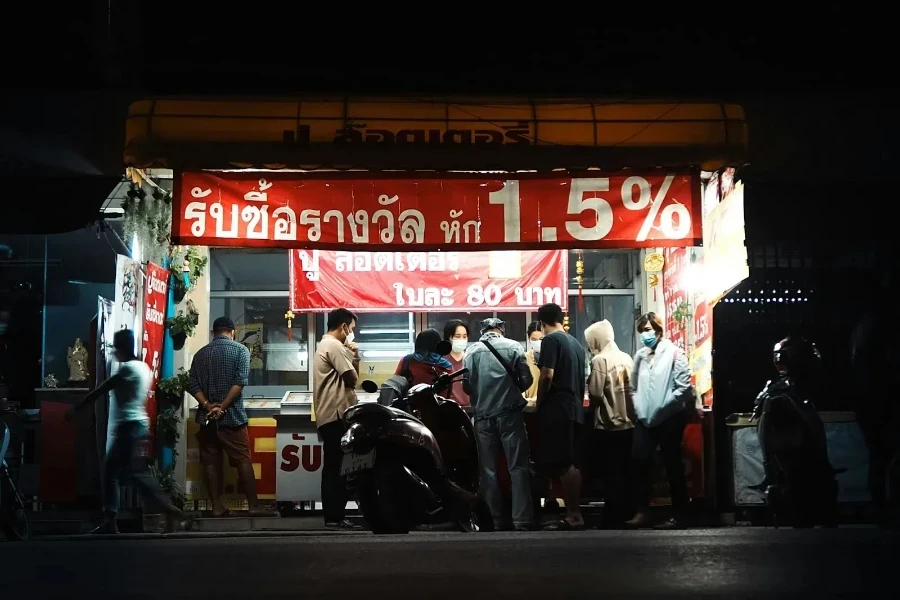 A group of people standing outside the promotion of a restaurant
