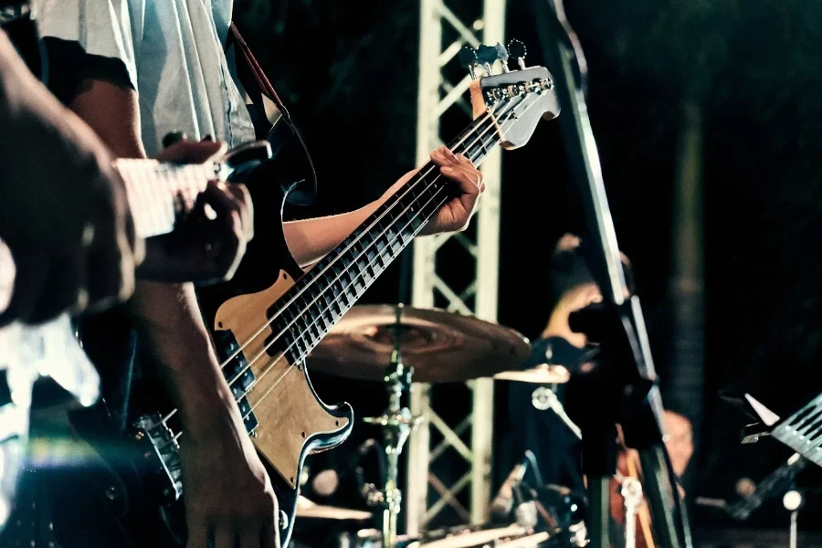 A man in a band playing guitar on stage