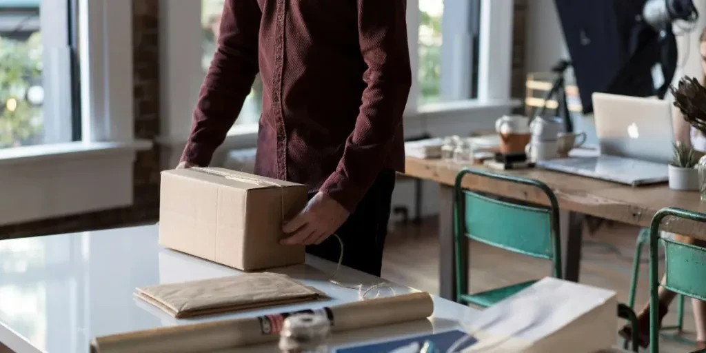 A man packaging the box on a table
