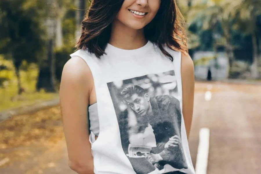 A woman wearing a printed t-shirt in an outdoor