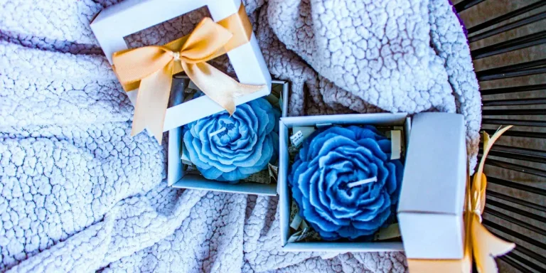Blue-flowered shape candles on a blanket