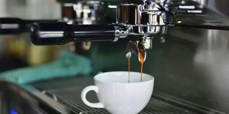 coffee machine pouring coffee to a white mug