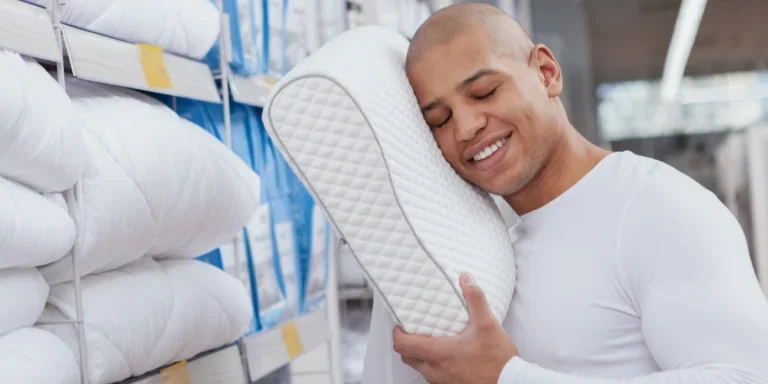 man trying out a cervical neck pillow in a store