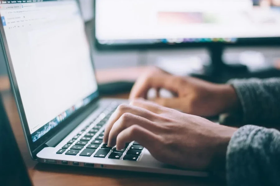Person typing on a macbook pro