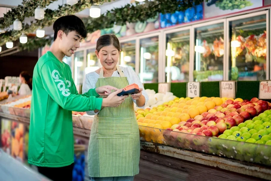 The old woman showing the products to a customer