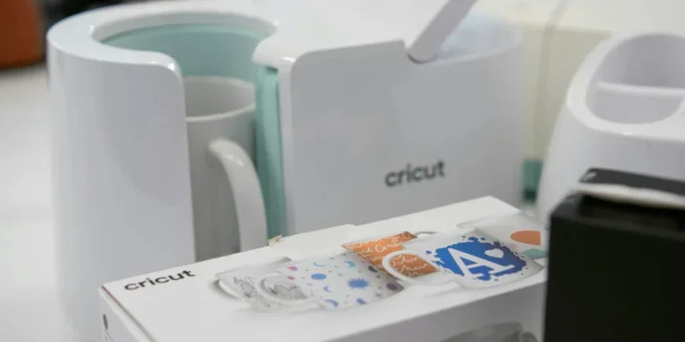 white cricut machine for mug alongside a box