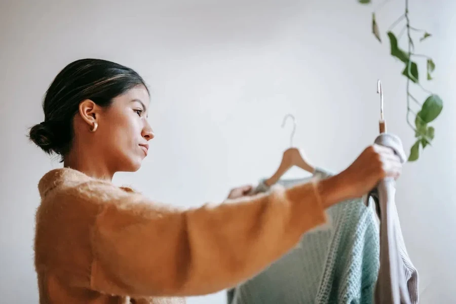 Woman comparing two pieces of clothing