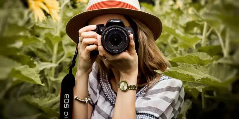 woman holding a dslr camera