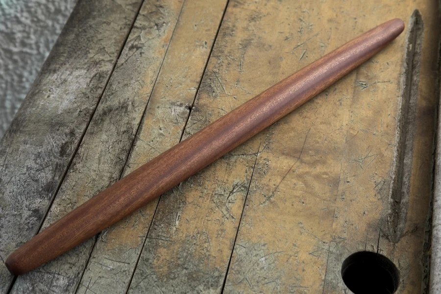 A French rolling pin on a wooden desk