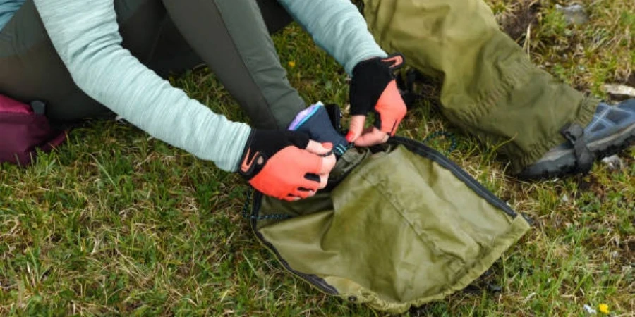 A Girl Hiker's Hand in Red Gloves