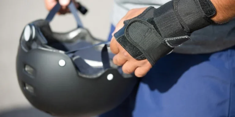 A Person Holding a Black Helmet