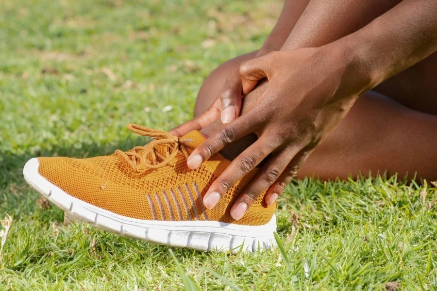 A Person Touching His Ankle