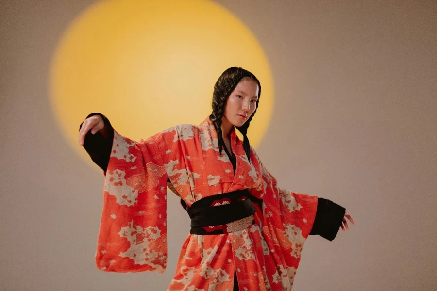 A Woman Wearing a Robe Standing Near the Spotlight