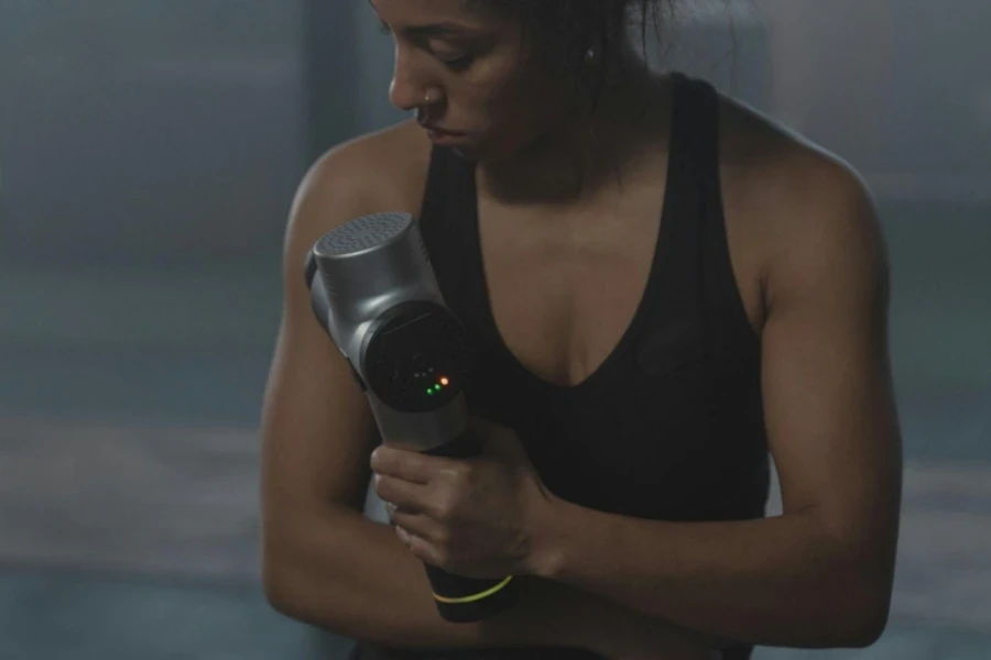 A Woman in Black Tank Top Exercising in the Gym