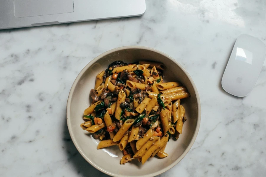 A bowl of pasta on a marble table