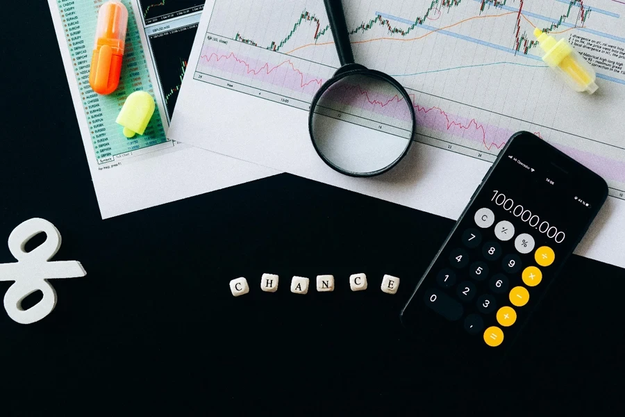 A calculator and magnifying glass on papers