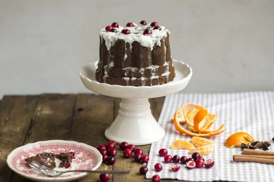 A chocolate cake on a ceramic cake stand