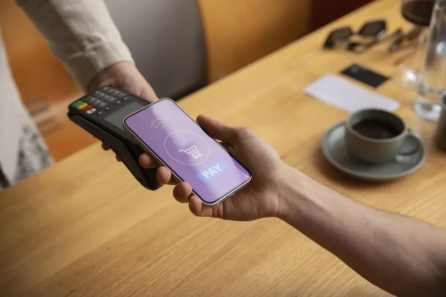 A customer paying with an NFC device