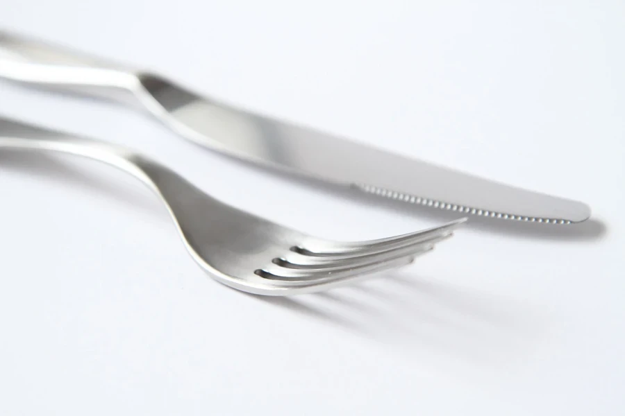 A fork and knife on a white surface