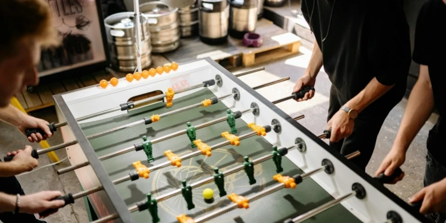 A group of people playing foosball