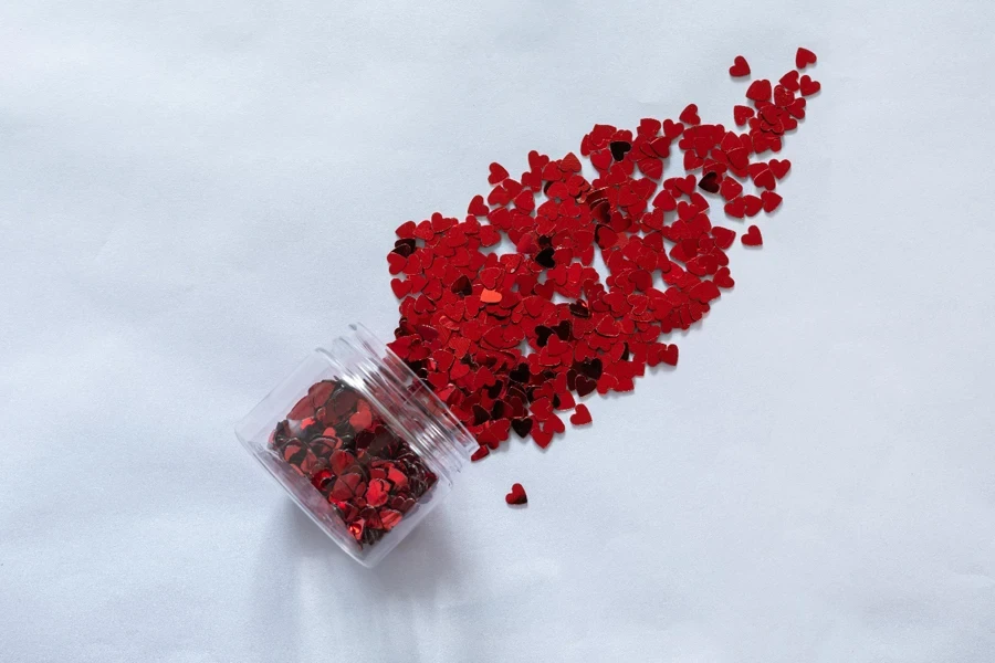 A jar of confetti shaped in red hearts