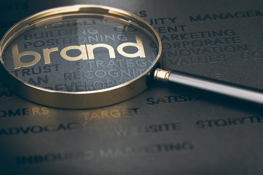 A magnifying glass focusing on the word “brand