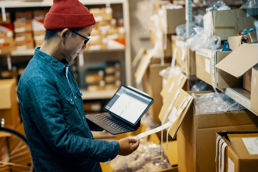 A man checking orders on his laptop