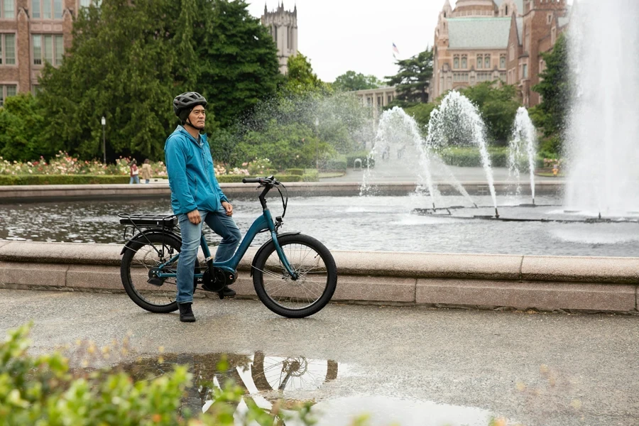 A man with an electric bike enjoys Seattle's scenic park and fountain view