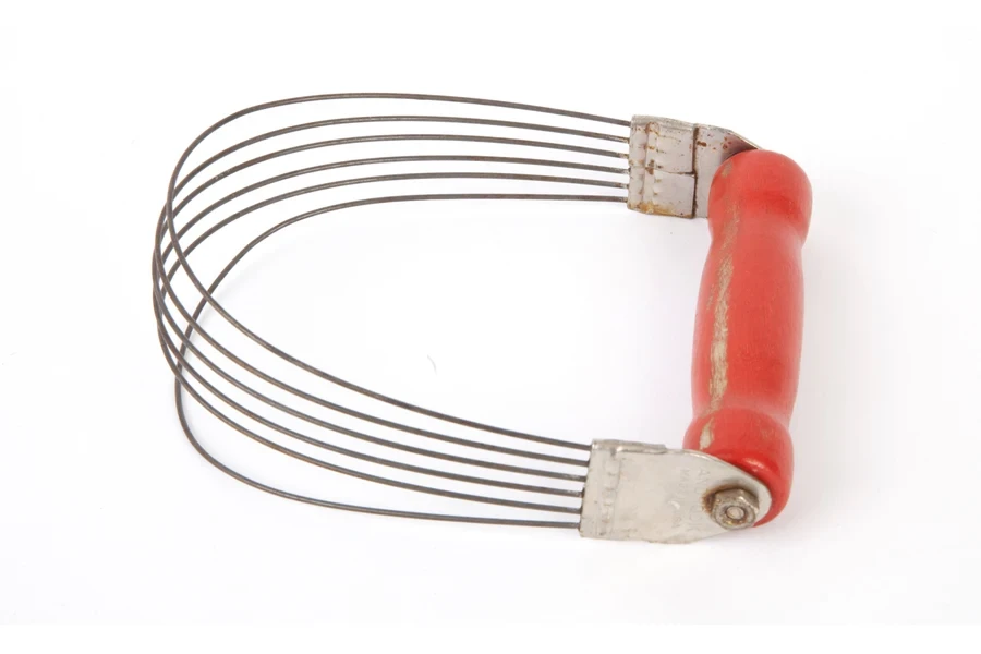 A pastry blender with a red silicone handle
