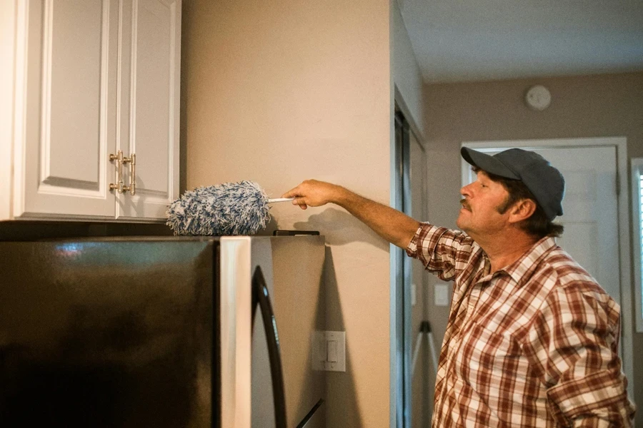 A person cleaning a refrigerator