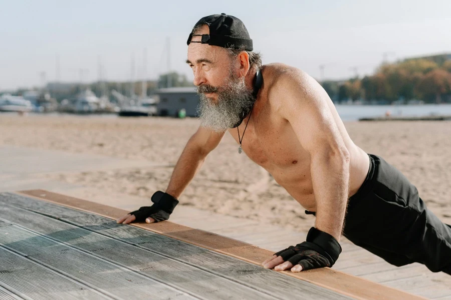 A person doing push ups on a beach