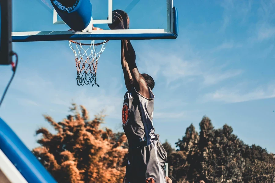 A person dunking a basketball hoop
