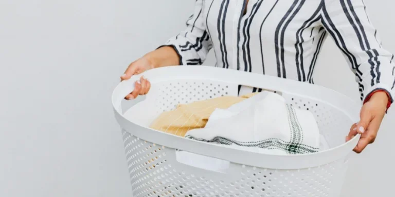 A person holding a laundry basket