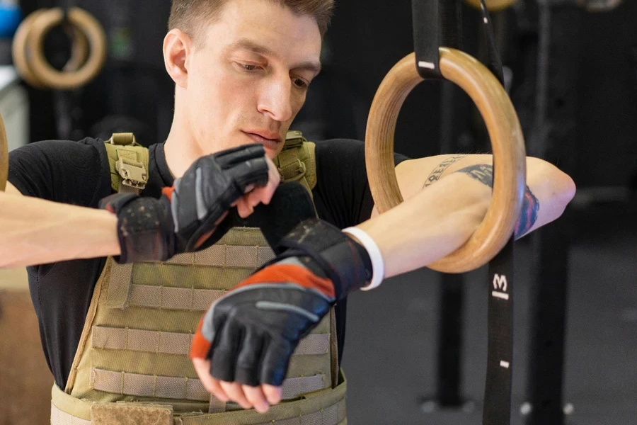 A person wearing gloves and holding a ring