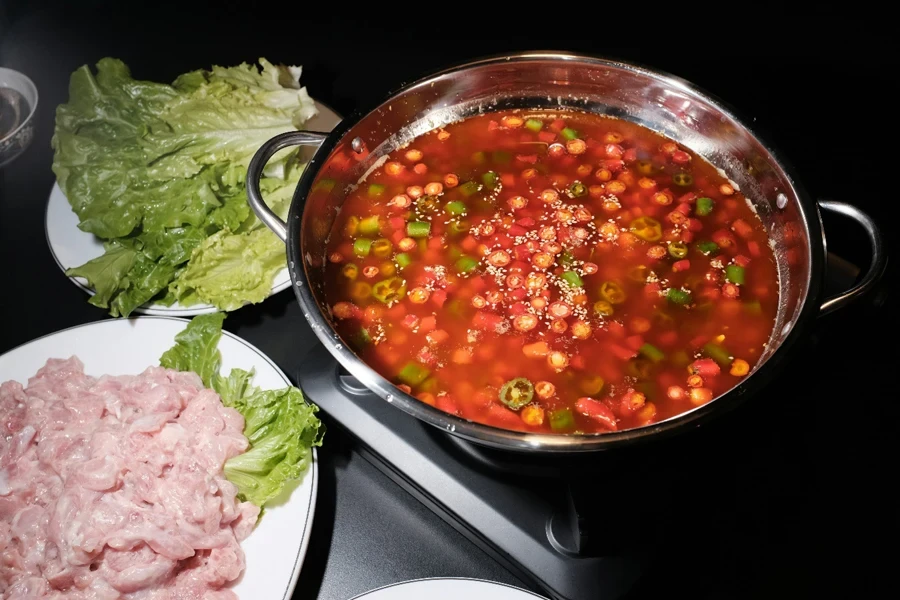 A pot of soup and some food