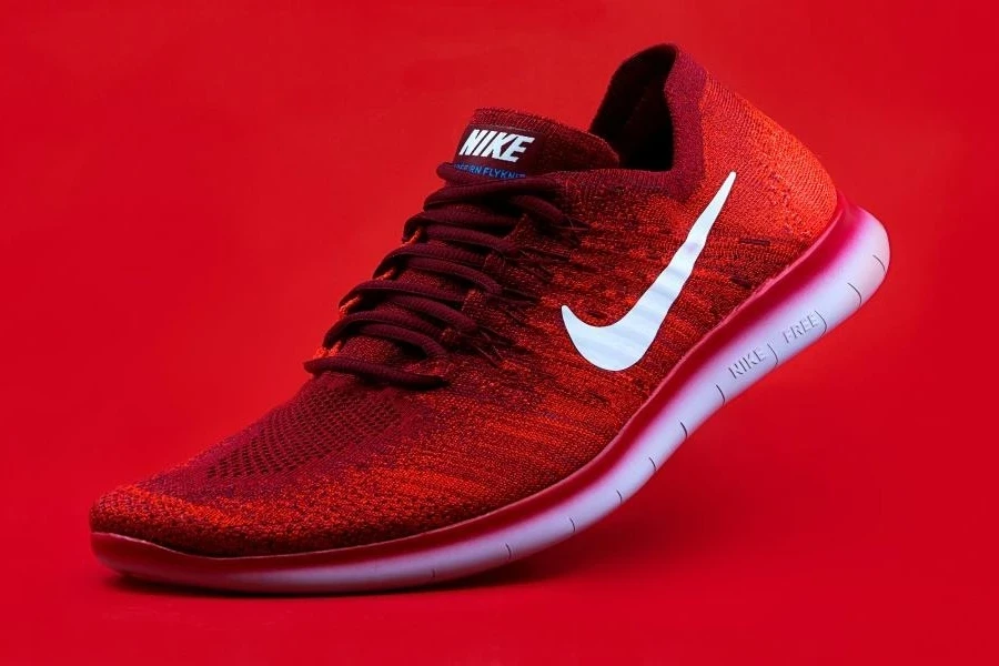 A red Nike pickleball shoe on a red background