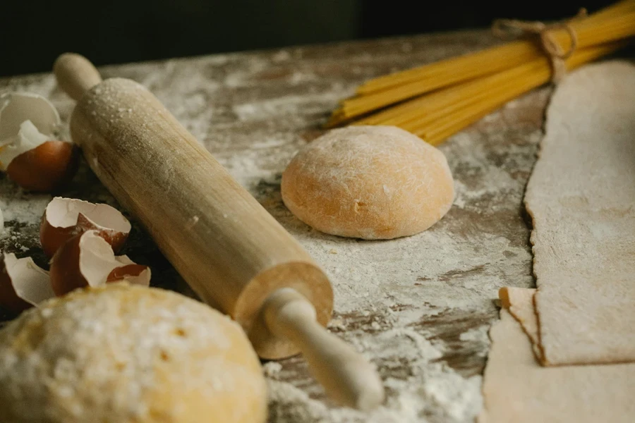 A rolling pin and dough on a table