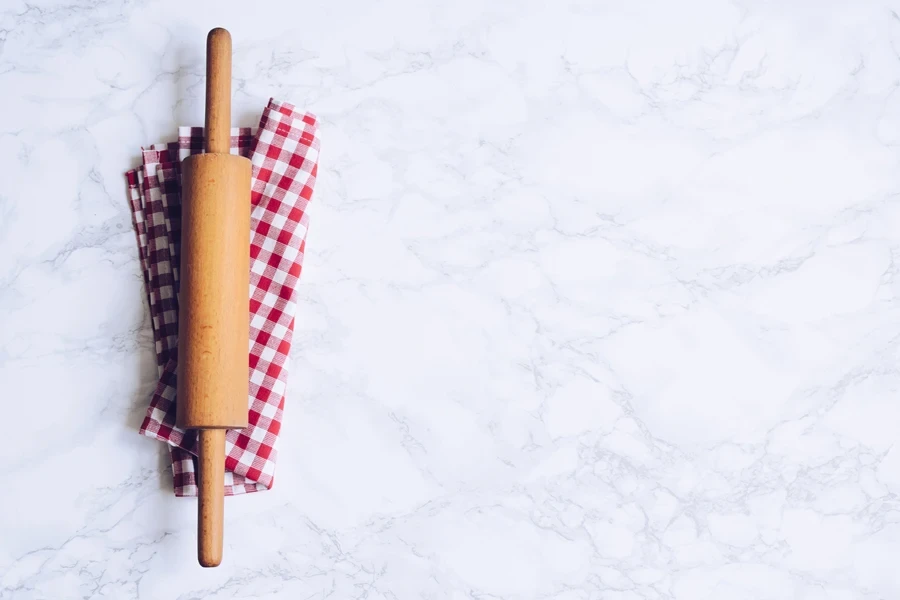 A rolling pin on a red and white napkin