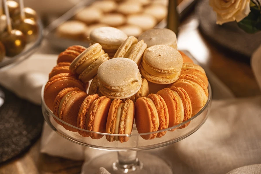 A small glass cake stand with macarons