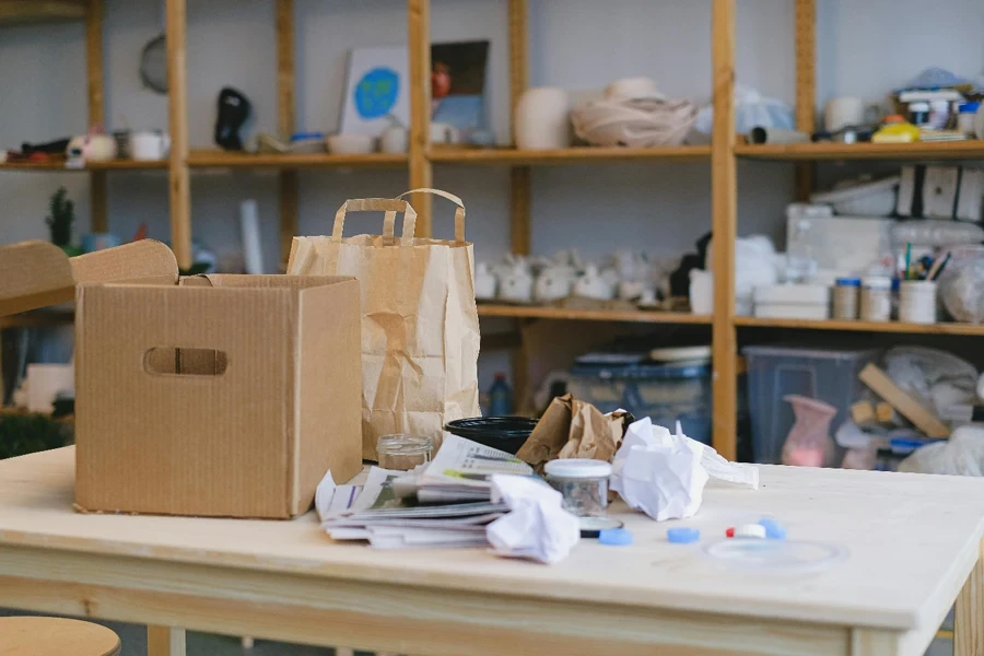 A table with paper bags and paper on it