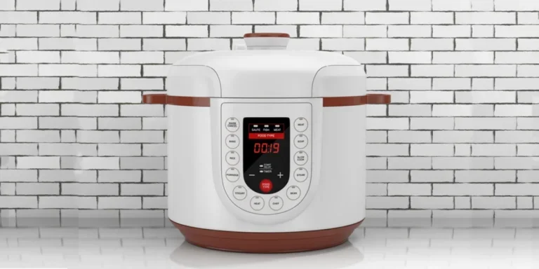 A white electric multi cooker near a brick wall