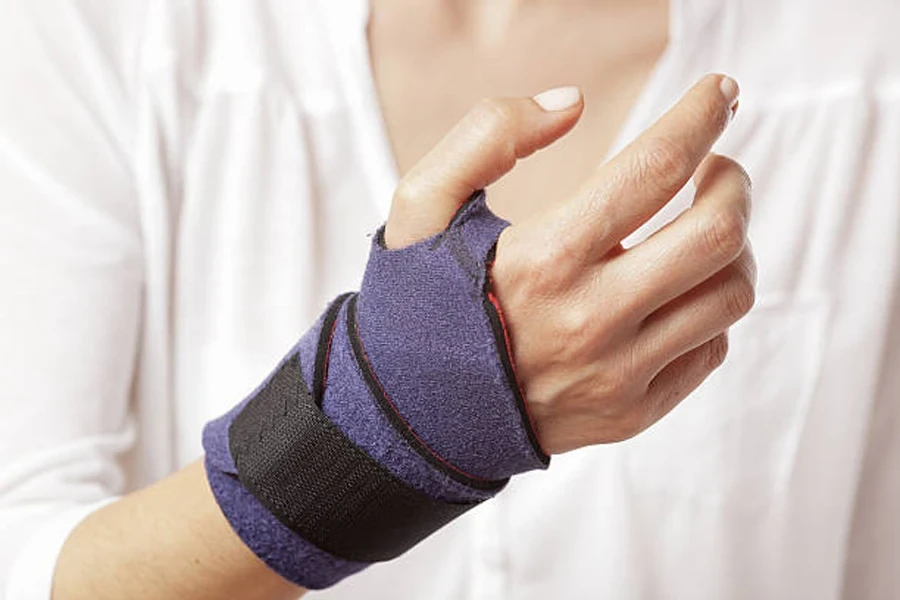 A woman has a bandage on her twisted wrist.