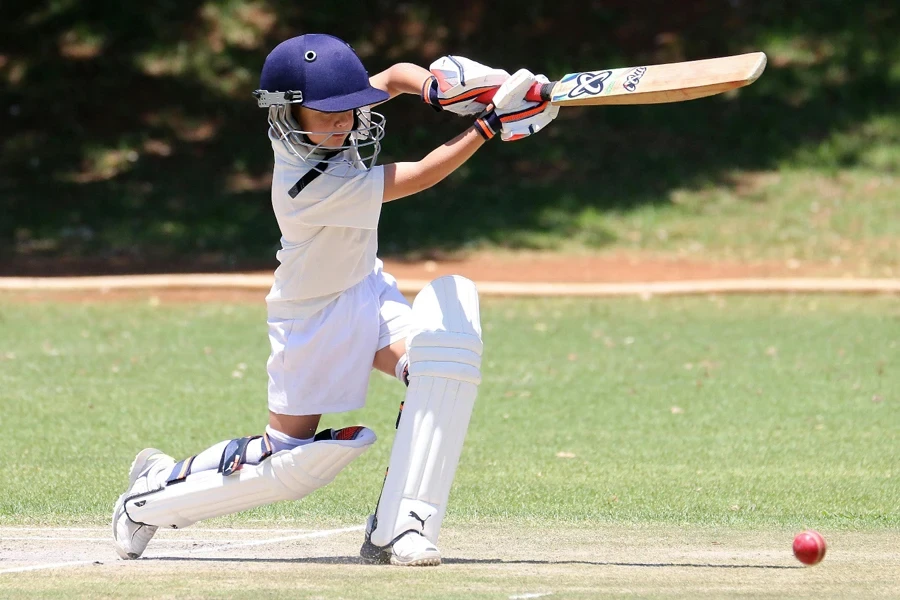 A young child playing cricket