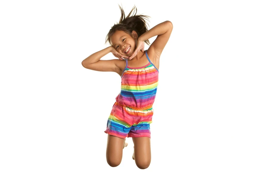 A young girl in a tie-dye outfit